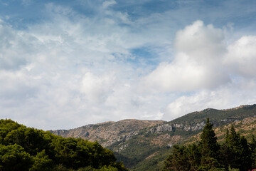 Sky with fluffy clouds over the hill