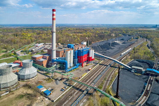 Modernized thermal power plant, general view of the installation in the spring landscape. Brick architecture, technical equipment and conveyors. Aerial views. Coal exit program.