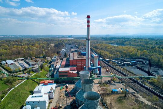 Modernized thermal power plant, general view of the installation in the spring landscape. Brick architecture, technical equipment and conveyors. Aerial views. Coal exit program.