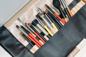 makeup brushes are in a drawer at the makeup artist's workplace. close-up