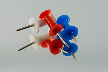 Draw Pins reflected on a mirror 