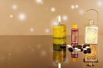 Vintage lamp, aromatic candle and oil, massage stones as a concept of SPA meditation, aromatherapy, physiotherapy, psychological balance, oriental beauty salon