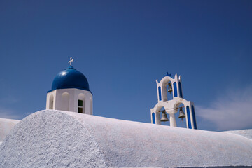Classic and famous landmarks of the Greek island, Santorini. Blue dome church set a top a white...