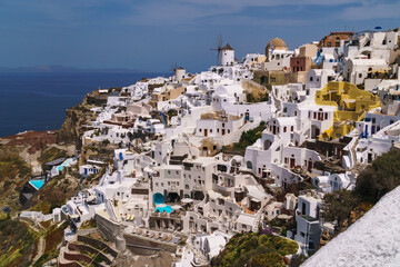 Fototapeta na wymiar Wide angle image of part of the town Oia in Santorini. Famous travel destination on the Greek island.