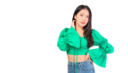 Attractive beautiful positive happy smile asian woman hands point up and pose with empty space wearing green shirt and jeans.