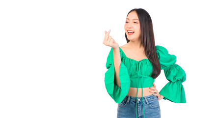 Attractive beautiful positive happy smile asian woman hands point up and pose with empty space wearing green shirt and jeans.