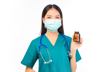 Portrait of professional asian female smiling doctor in green scrubs holding a brown pill bottle Medical Care.