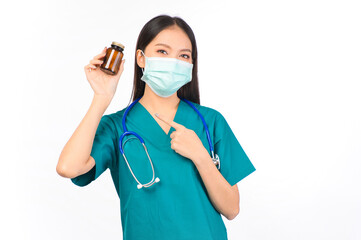 Portrait of professional asian female smiling doctor in green scrubs holding a brown pill bottle Medical Care.