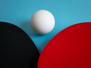 Detail of pingpong rackets and ball isolated on light blue background. Equipment for playing table tennis.