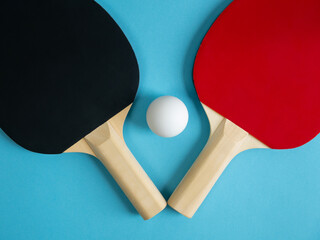 Pingpong rackets and ball isolated on light blue background. Equipment for playing table tennis.
