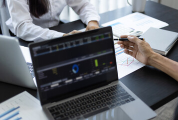 Accountants working on financial statement on laptop screen in office. Business consulting meeting working and brainstorming new business project finance investment concept.