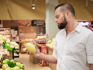 Fototapeta premium Man buy fruits and vegetables at supermarket