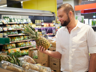 Man buy fruits and vegetables at supermarket