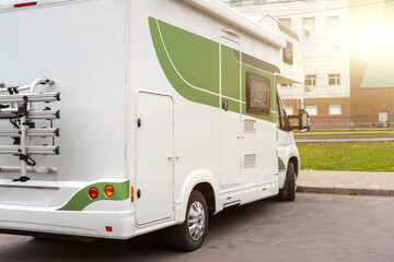 Modern camper van parked on city street. RV motorhome camper van parked in town