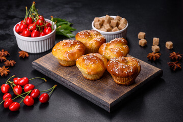 Fresh delicious rice flour muffins with cherries on a concrete background. Homemade pastries