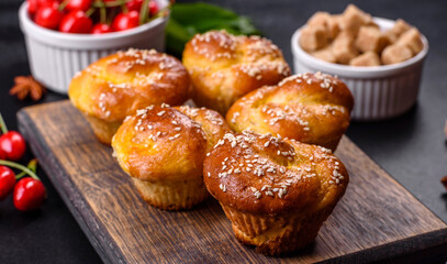 Fresh delicious rice flour muffins with cherries on a concrete background. Homemade pastries