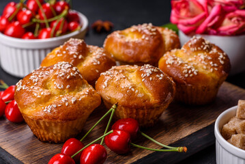 Fresh delicious rice flour muffins with cherries on a concrete background. Homemade pastries
