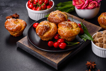 Fresh delicious rice flour muffins with cherries on a concrete background. Homemade pastries