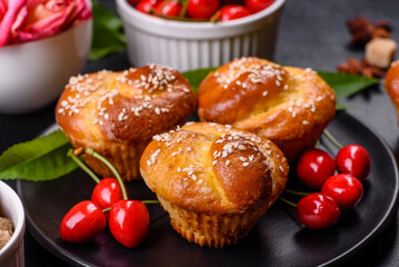 Fresh delicious rice flour muffins with cherries on a concrete background. Homemade pastries