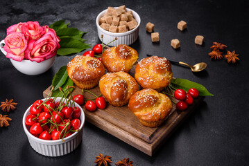 Fresh delicious rice flour muffins with cherries on a concrete background. Homemade pastries