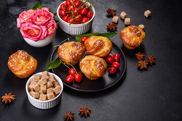 Fresh delicious rice flour muffins with cherries on a concrete background. Homemade pastries