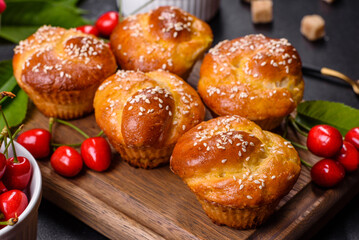 Fresh delicious rice flour muffins with cherries on a concrete background. Homemade pastries