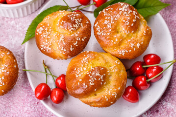 Fresh delicious rice flour muffins with cherries on a concrete background. Homemade pastries