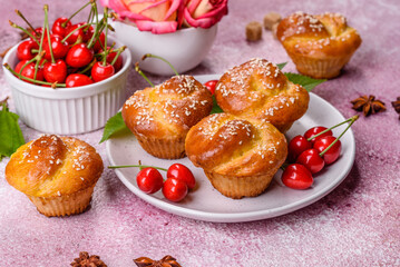 Fresh delicious rice flour muffins with cherries on a concrete background. Homemade pastries