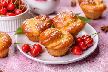 Fresh delicious rice flour muffins with cherries on a concrete background. Homemade pastries