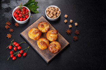 Fresh delicious rice flour muffins with cherries on a concrete background. Homemade pastries