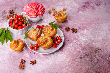 Fresh delicious rice flour muffins with cherries on a concrete background. Homemade pastries