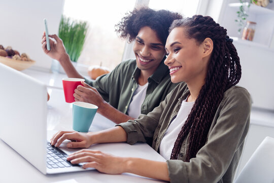 Photo Of Good Mood Siblings Brother And Sister Have Morning Coffee Surfing In Social Media Laptop Do Online Shopping