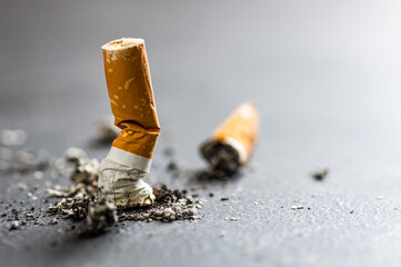 Cigarette butt on floor, environmental pollution, cigarette yellow filters