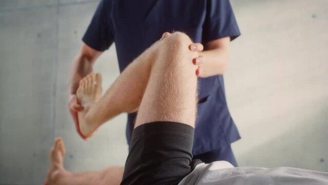 Close Up of a Sportsman Patient Undergoing Physical Therapy to Recover from Surgery and Increase Mobility. Physiotherapist Works on Specific Muscle Groups or Joints to Rehabilitate from Injury.
