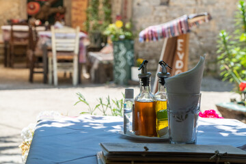 Traditional decorated greek terrace. Close-up of vinegar and olive oil on table. High quality photo