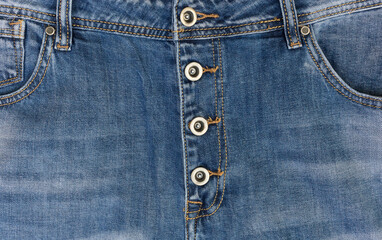 Fototapeta premium Fragmnt of denim trousers. Clasp jeans for metal buttons.