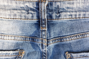 Fragmnt of denim trousers. The back of denim trousers, belt straps