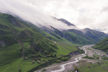 Fototapeta premium birds-eye view of old Military Road between Georgia and Russia in Dariali gorge, river Tergi, Georgia. High quality photo