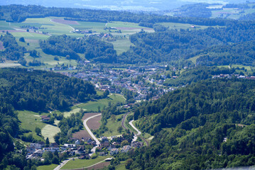 Fototapeta premium Aerial view of midland with agricultural fields, wood and hills seen from local mountain Uetliberg on a sunny spring day. Photo taken May 18th, 2022, Zurich, Switzerland.