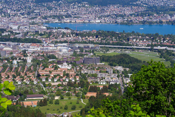Fototapeta premium Aerial view of City of Zürich and Lake Zürich seen from local mountain Uetliberg on a sunny spring day. Photo taken May 18th, 2022, Zurich, Switzerland.