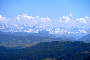 Fototapeta premium Aerial view of landscape at Canton Zürich with the Swiss Alps in the background seen from local mountain Uetliberg on a sunny spring day. Photo taken May 18th, 2022, Zurich, Switzerland.