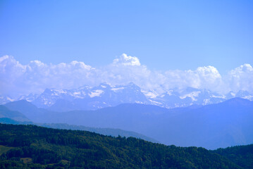 Aerial view of landscape at Canton Zürich with the Swiss Alps in the background seen from local mountain Uetliberg on a sunny spring day. Photo taken May 18th, 2022, Zurich, Switzerland.