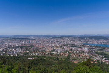 Fototapeta na wymiar Aerial view of City of Zürich and Lake Zürich seen from local mountain Uetliberg on a sunny spring day. Photo taken May 18th, 2022, Zurich, Switzerland.