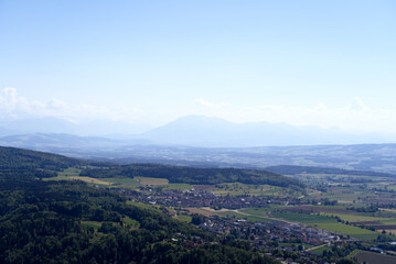 Fototapeta na wymiar Aerial view of landscape at Canton Zürich with the Swiss Alps and Mount Pilatus in the background on a sunny spring day. Photo taken May 18th, 2022, Zurich, Switzerland.