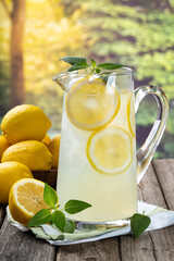 Pitcher of lemonade with summer background - obrazy, fototapety, plakaty