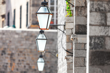 Vintage street lamp on the wall side . Lanterns and brick wall
