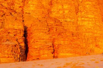 Cliff with rock formation, in sunset light. Wadi Rum