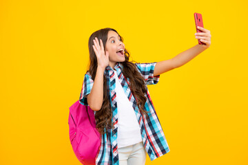 Smartphone and school child. Student girl with phone on isolated background.