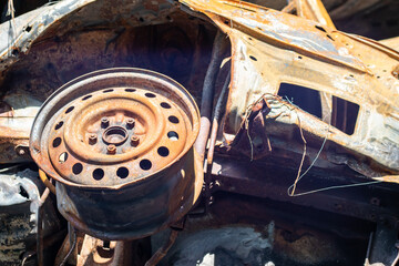 Broken and burned cars in the parking lot, accident or deliberate vandalism. Burnt car. Consequences of a car accident. Damaged by arson. Dump of civilian vehicles shot by Russian troops in Ukraine.