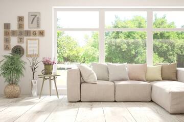 Fototapeta premium White living room with sofa and summer landscape in window. Scandinavian interior design. 3D illustration